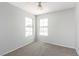 Bright bedroom with two windows, neutral walls, and carpeted flooring at 6112 Grape Blossom Ave, Las Vegas, NV 89142