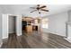 Open living space showcasing hardwood floors, ceiling fan, and views into the kitchen for easy entertaining at 6112 Grape Blossom Ave, Las Vegas, NV 89142