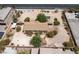 Aerial view of home sitting on a sand lot with desert landscaping and block wall fence at 6337 W Cactus Ave, Las Vegas, NV 89141