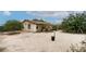 Exterior view of home's backyard and exterior with minimal landscaping at 6337 W Cactus Ave, Las Vegas, NV 89141