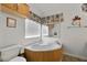 Bathroom with soaking tub, window for natural light, and neutral decor at 6337 W Cactus Ave, Las Vegas, NV 89141