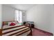 Bedroom with carpeted floors, a small desk, and a twin bed with neutral bedding at 6337 W Cactus Ave, Las Vegas, NV 89141