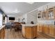 Open kitchen and dining area features wood floors, island, and glass front cabinets at 6337 W Cactus Ave, Las Vegas, NV 89141