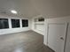 Bright living room featuring wood-look floors, built-in shelving and natural light from the large windows at 6412 Point Break St, North Las Vegas, NV 89084