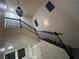 Beautiful staircase with black railings and white walls, leading to the upper level of the home at 6412 Point Break St, North Las Vegas, NV 89084