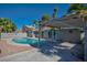 Inviting backyard pool with ample patio space, perfect for outdoor relaxation and entertaining under a covered pergola at 6848 Groveview Ln, Las Vegas, NV 89103