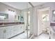 Bathroom featuring a double sink vanity, large mirror, and a view of the toilet and shower area at 6848 Groveview Ln, Las Vegas, NV 89103