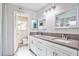 Bright bathroom featuring a double sink vanity with white cabinets and a gray countertop at 6848 Groveview Ln, Las Vegas, NV 89103
