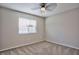 Neutral bedroom featuring a ceiling fan, plush carpet, and a window with blinds at 6848 Groveview Ln, Las Vegas, NV 89103