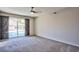 Comfortable bedroom featuring neutral tones, carpeted flooring, and access to the backyard pool at 6848 Groveview Ln, Las Vegas, NV 89103