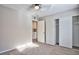 Neutral bedroom with ceiling fan, closet with sliding doors, and built in cabinets at 6848 Groveview Ln, Las Vegas, NV 89103
