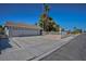 Attractive home with a three-car garage, landscaped front yard, and secure perimeter fence at 6848 Groveview Ln, Las Vegas, NV 89103