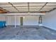 Spacious garage featuring high ceilings, storage space and an open garage door at 6848 Groveview Ln, Las Vegas, NV 89103