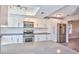 Bright kitchen with white cabinets, stainless steel appliances, and a spacious island at 6848 Groveview Ln, Las Vegas, NV 89103
