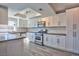 Modern kitchen featuring white cabinets, stainless steel appliances, and light gray countertops at 6848 Groveview Ln, Las Vegas, NV 89103