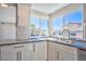Kitchen sink under a bay window with gray countertops and white cabinets at 6848 Groveview Ln, Las Vegas, NV 89103
