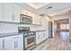 Well-lit kitchen with stainless steel appliances, gray countertops, and white cabinets at 6848 Groveview Ln, Las Vegas, NV 89103