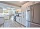 Modern kitchen featuring stainless steel appliances, subway tile backsplash, and stylish wood-like tile flooring at 6848 Groveview Ln, Las Vegas, NV 89103