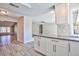Open concept kitchen with gray countertops, tile backsplash, and wood-look flooring at 6848 Groveview Ln, Las Vegas, NV 89103