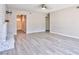 Spacious living room featuring wood-look tile floors and a white painted brick fireplace at 6848 Groveview Ln, Las Vegas, NV 89103