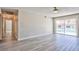 Open living room with sliding glass doors leading to a pool and neutral paint at 6848 Groveview Ln, Las Vegas, NV 89103