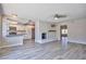 Open-concept living area with a charming brick fireplace and seamless flow into the modern kitchen at 6848 Groveview Ln, Las Vegas, NV 89103