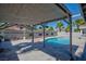 Backyard pool featuring a covered patio and lush greenery, creating a private outdoor oasis at 6848 Groveview Ln, Las Vegas, NV 89103
