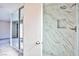 New shower with designer tile work, shower head, and built-in toiletry shelf at 6848 Groveview Ln, Las Vegas, NV 89103