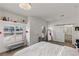 Bright bedroom with a sliding barn door to the bathroom, accent mirror and ample natural light at 712 Proud Eagle Ln, Las Vegas, NV 89144