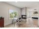 Bright bedroom boasts a modern fireplace, a dedicated desk area, and hardwood flooring at 712 Proud Eagle Ln, Las Vegas, NV 89144