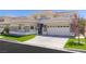 Beautiful home featuring stone accents, a three-car garage, and a well-kept lawn at 712 Proud Eagle Ln, Las Vegas, NV 89144