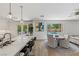 Bright living room features a kitchen island, and view of the backyard pool at 712 Proud Eagle Ln, Las Vegas, NV 89144