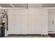 Spacious garage featuring ample storage with floor to ceiling white storage cabinets at 7201 Mission Hills Dr, Las Vegas, NV 89113