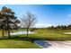 Scenic view of the pristine golf course featuring a tranquil pond and lush greenery at 7201 Mission Hills Dr, Las Vegas, NV 89113