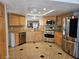 Updated kitchen with stainless steel appliances, light wood cabinetry, and granite countertops at 7201 Mission Hills Dr, Las Vegas, NV 89113