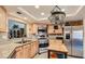 Open kitchen featuring stainless steel appliances, light wood cabinetry, and granite countertops at 7201 Mission Hills Dr, Las Vegas, NV 89113