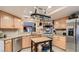 Well-lit kitchen featuring stainless steel appliances, light wood cabinetry, and granite countertops at 7201 Mission Hills Dr, Las Vegas, NV 89113