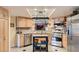 Well-lit kitchen featuring stainless steel appliances, light wood cabinetry, and granite countertops at 7201 Mission Hills Dr, Las Vegas, NV 89113