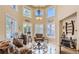 Bright living room with high ceilings, a decorative chandelier and large picture windows at 7201 Mission Hills Dr, Las Vegas, NV 89113