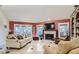 Cozy living room features a fireplace, large TV, and comfortable seating for relaxation and entertainment at 7201 Mission Hills Dr, Las Vegas, NV 89113
