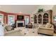 Spacious living room featuring a decorative fireplace, built-in bookcase, and comfortable furniture at 7201 Mission Hills Dr, Las Vegas, NV 89113