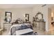 Elegant bedroom with a decorative bed frame, matching dressers, and neutral color palette at 7201 Mission Hills Dr, Las Vegas, NV 89113
