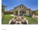 Spacious backyard with lush green grass, a cozy fire pit area, and comfortable seating, perfect for outdoor entertaining at 776 Tillis Pl, Las Vegas, NV 89138