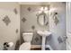 Powder room featuring unique wall décor and a pedestal sink at 776 Tillis Pl, Las Vegas, NV 89138