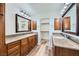 Large bathroom with double sinks, granite counters, and a walk-in closet at 776 Tillis Pl, Las Vegas, NV 89138