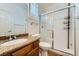 Bathroom featuring granite countertop, wood cabinets, and a glass-enclosed shower at 776 Tillis Pl, Las Vegas, NV 89138
