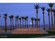 Entrance to Summerlin with desert landscaping and palm trees at dusk at 776 Tillis Pl, Las Vegas, NV 89138