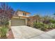 Charming two-story home with a well-maintained lawn and a two-car garage, featuring a blend of stucco and stone accents at 776 Tillis Pl, Las Vegas, NV 89138