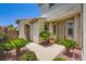 Charming home entrance with lush landscaping and an arched walkway, creating an inviting and picturesque welcome at 776 Tillis Pl, Las Vegas, NV 89138