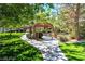 A serene gazebo and shaded seating area is surrounded by lush landscaping at 776 Tillis Pl, Las Vegas, NV 89138